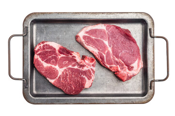 Raw pork neck meat steaks on steel tray isolated on white background. top view