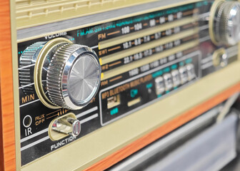 A radio with a volume button and a button for bluetooth