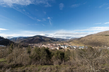 Small town nestled in the pyrenees mountains on a sunny day with blue sky