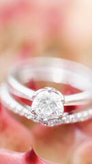 Close-up of diamond engagement ring on soft background