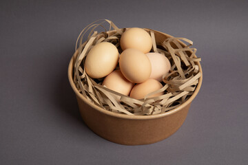 Brown eggs in kraft bowl – top view