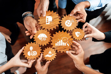 Hands gather around wooden gears, each symbolizing key business concepts. The image promotes...