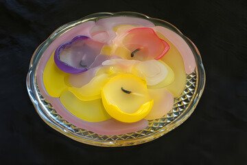A colorful palette of spent candles on a plate

