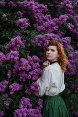 Young pretty caucasian woman in romantic outfit walking in blooming spring garden. Artistic outdoor photo of beautiful red-haired girl posing in fragrant lilac blossom.