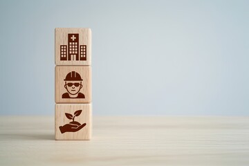 Wooden blocks stacked with icons representing a hospital a worker and a plant growing from a hand symbolizing healthcare and growth