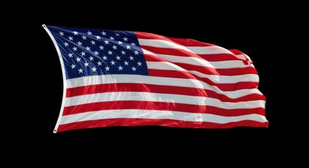 Fototapeta premium A symbol of American pride isolated on black. The flag of the United States is shown waving against a solid black background for a dramatic effect.