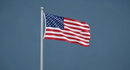 Fototapeta premium US Flag on a Pole Against a Deep Blue Sky