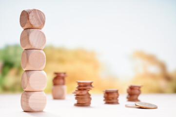 Stacked wooden blocks and coins illustrating sustainable financial planning and growth with a...