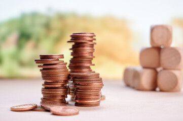 Stacked coins and wooden blocks symbolizing financial planning, growth, and investment with blurred...