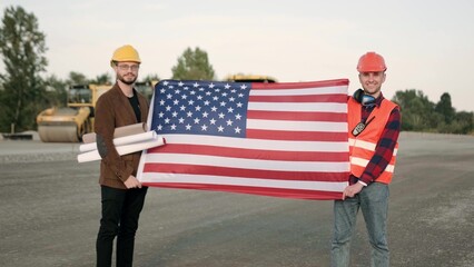 American builders holding blueprints, ready to work on site