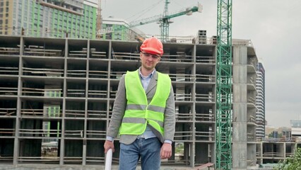 Pleased foreman posing for camera after building site inspection