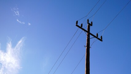 low voltage electric pole against the sky