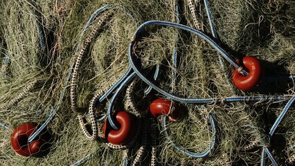 still life of fishing net threads, rope and buoy