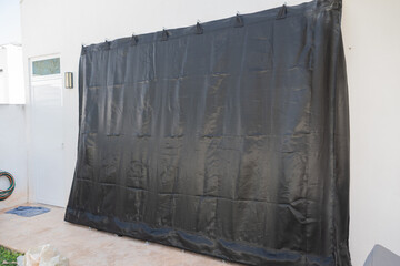 Hurricane tarpaulin placed on the windows of a house to protect against the arrival of a cyclone.