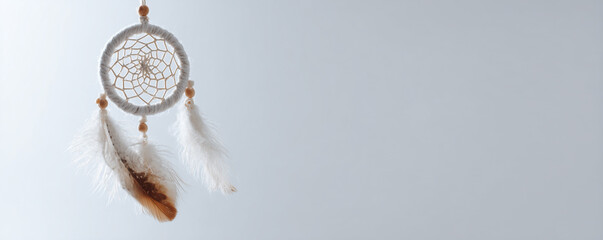 Dream catcher with feathers hanging against a light background, symbolizing protection and positive energy in a serene setting Generative AI