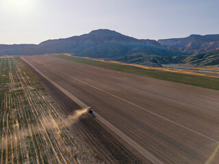 Nallihan Bird Sanctuary  Beypazari Ankara Turkey Aerial View of a Tractor Working a Farm Field. High-angle, full shot of a tractor working a large, flat farm field. Nallıhan Kus Cenneti Beypazari