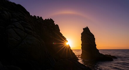 Ocean Sunset with Rocks Silhouette and Sun Rays