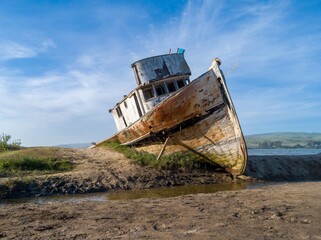The Point Reyes shipwreck, a historic fishing boat, rests on the shore in Inverness, California,...