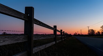 Wooden Fence Along Rural Road at Twilight with Colorful Sky
