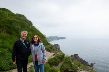 Old Head, Kinsale, Ireland, May 26, 2024: Old Head Peninsula looking at the rugged cliff eith people enjoying the day