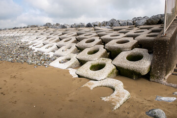 Old Head Beach, Kinsale, Ireland,  is picturesquely situated on the edge of dense forests looking at the Beach Erosion Stabilization Blocks near the bridge