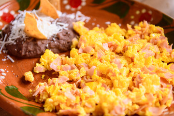 Scrambled eggs with ham and beans, traditional mexican breakfast