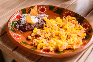Scrambled eggs with ham and beans, traditional mexican breakfast