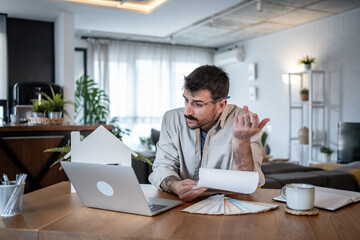 Architect working from home having video call discussing house plans