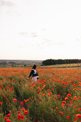 Experiencing Joyful Moments while immersing oneself in a stunning and vibrant Poppy Field A truly...
