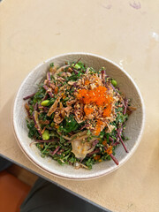 Poke bowl with kale, salmon, and roe.