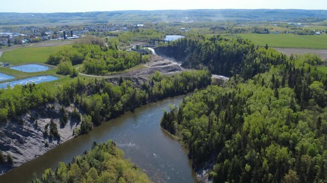 Panoramic aerial view of the Mitis-1 dam hydroelectric power station, built on a natural waterfall on the renowned Mitis River salmon sport fishing river, Price village, Quebec, Canada, 2025.