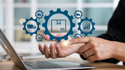 Person using laptop with digital logistics icons floating above hand in blurred setting
