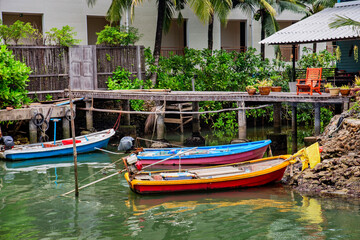 LTraditional Thai boats in a river flowing into the sea at Kai Bae Beach on Koh Chang Island