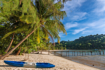 Beautiful landscape with kayak and palm trees and low tide sea at Bang Bao Bay, Koh Kood island