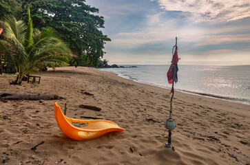 Plastic orange beach chair on White sand beach on Koh Chang island