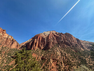 zion national park on clear blue day with stunning mountain range from watchmans trail