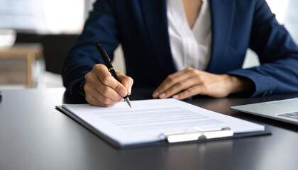 Woman in business suit sits at sleek desk, her hand poised over document as she prepares to sign. atmosphere conveys professionalism and focus, highlighting her determination