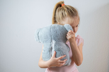 preschool sweet girl finds comfort in toy, emphasizing importance emotional support in early years,...