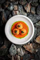 Crab Croquettes with Roasted Pepper Sauce and Wakame on stones