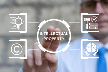 Business person using virtual interface sees inscription: INTELLECTUAL PROPERTY. Intellectual...