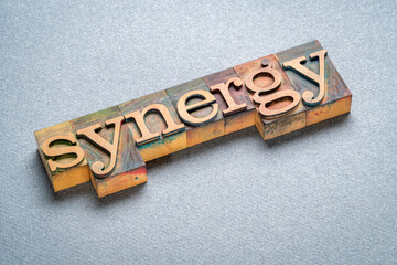 synergy, word in vintage letterpress wood type, integration and teamwork concept