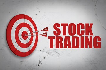 Red and white target with arrows in the bullseye next to the words stock trading on wall