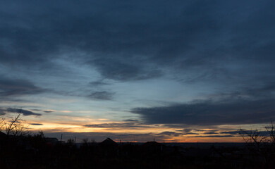 Fototapeta premium Landscape at sunset. Tragic gloomy sky. Panorama. Crimson twilight.