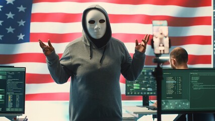 Person in anonymous mask working on intelligence in a governmental hacking room, recording himself...