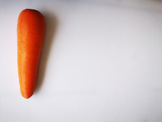 Fresh orange carrot isolated on a white background, minimal food and vegetable concept.
