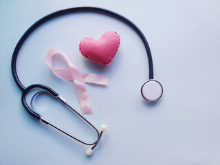 
heart and pink ribbon representing pink october, awareness against breast cancer in women with...