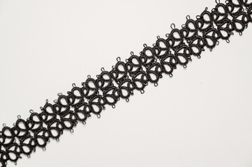 Handmade jewelry.Closeup texture of Necklace or bracelet made with Tatting or frivolite...