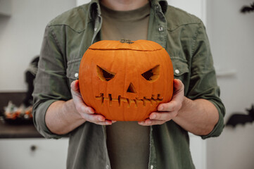 Closeup pf spooky halloween lantern in man's hand. Festive banner