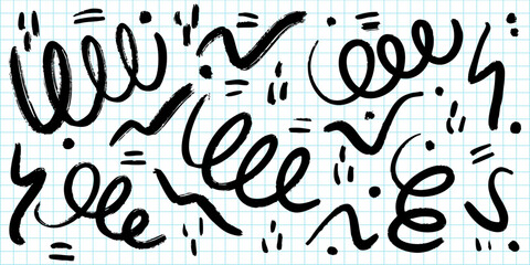 collection of abstract black brushstroke doodles and scribbles on a blue graph paper background.