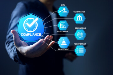 Compliance concept with businessman holding blue theme checkmark to comply the law regulation requirement and standard